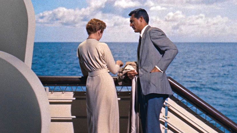 Photograph from An Affair to Remember (1957) featuring Deborah Kerr (as Terry McKay) and Cary Grant (as Nickie Ferrante). The pair are chatting by the railings of a cruise ship at sea
