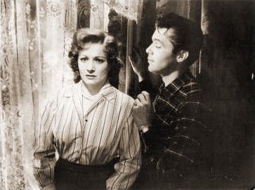 Margaret Lockwood (as Freda Jeffries) and Dirk Bogarde (as Edward Bare) in a photograph from Cast a Dark Shadow (1955) (2)