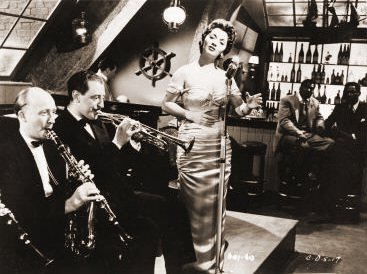 Lita Roza (as Singer) in a photograph from Cast a Dark Shadow (1955) (36)