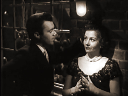 Dirk Bogarde (as Edward Bare) and Margaret Lockwood (as Freda Jeffries) in a screenshot from Cast a Dark Shadow (1955) (2)