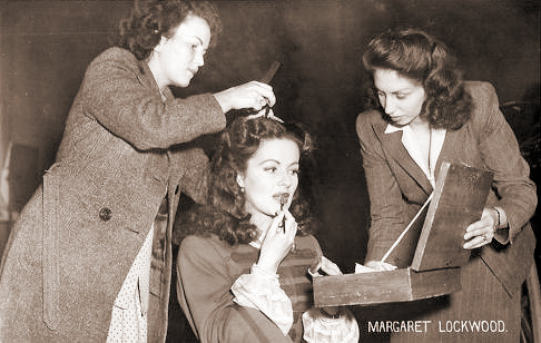 The hairdresser and make-up artist attend to Margaret Lockwood on the set of The Wicked Lady