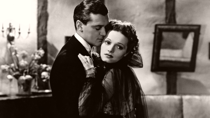 Hugh Williams (as Jim Wyndham) and Linden Travers (as Helen Norwood Bernardy) in a photograph from Brief Ecstasy (1937)