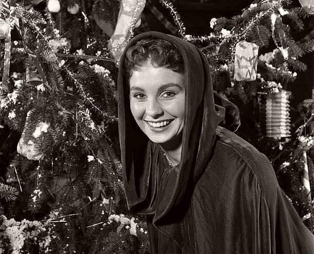 Scenes from Jean Simmons’ Christmas Party organised by ‘Picturegoer’ magazine. British actress and party host Jean Simmons is pictured next to a Christmas tree. Pinewood Studios, 1949.