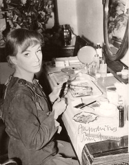 Joan Greenwood looks up from her dressing room table as she prepares for her next performance in the title role of Peter Pan.  Autographed photo reads ‘All good wishes, Joan Greenwood’