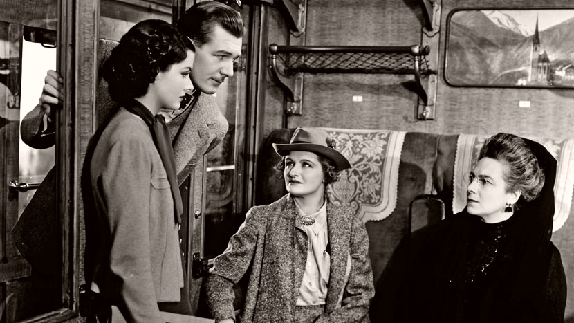 Iris (Margaret Lockwood) and Gilbert (Michael Redgrave) investigate the disappearance of Miss Froy on board a train in The Lady Vanishes