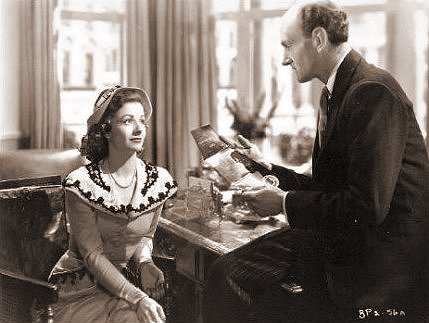 Margaret Lockwood (as Ann Markham) and Maurice Denham (as Fosser) in a photograph from Look Before You Love (1948) (10)