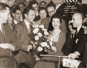 Griffiths Jones, Hugh Huth and Margaret Lockwood and members of the crew of Look Before You Love (clapper board shows the working title, ‘I Know You’)