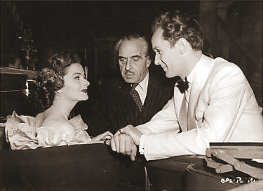 Margaret Lockwood chats with director Harold Huth and co-star Griffith Jones during a break from filming Look Before You Love