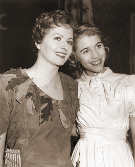Mother and daughter (Margaret Lockwood and Julia Lockwood) smile happily as they perform together in Peter Pan at the Scala Theatre, London, in 1957.  Margaret plays Peter Pan and Julia Wendy