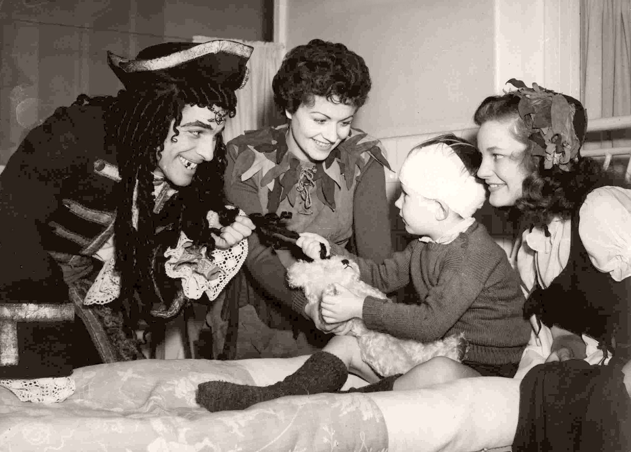 At London’s Great Ormond Street Hospital, the sick children are entertained by Peter Pan (Margaret Lockwood) and Captain Hook (John Justin)
