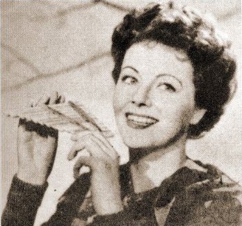 In costume for Peter Pan, Margaret Lockwood plays the panpipes (1950)