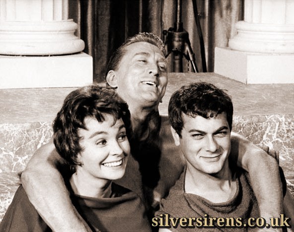 Jean Simmons, Kirk Douglas and Tony Curtis laugh happily in a candid shot taken during a break from filming on the set of Spartacus