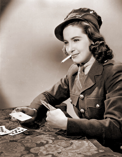 Patricia Roc smokes while she plays cards