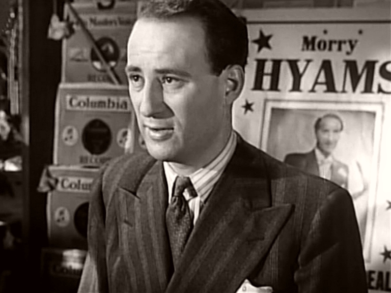 Morry Hyams (Sydney Tafler) in his store in a scene from It Always Rains on Sunday (1947)