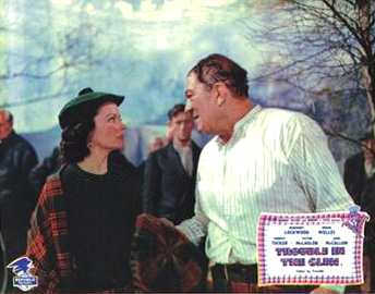 Margaret Lockwood (as Marissa Menzies) and Forrest Tucker (as Major Lance Lansing) in a lobby card from Trouble in the Glen (1954) (14)