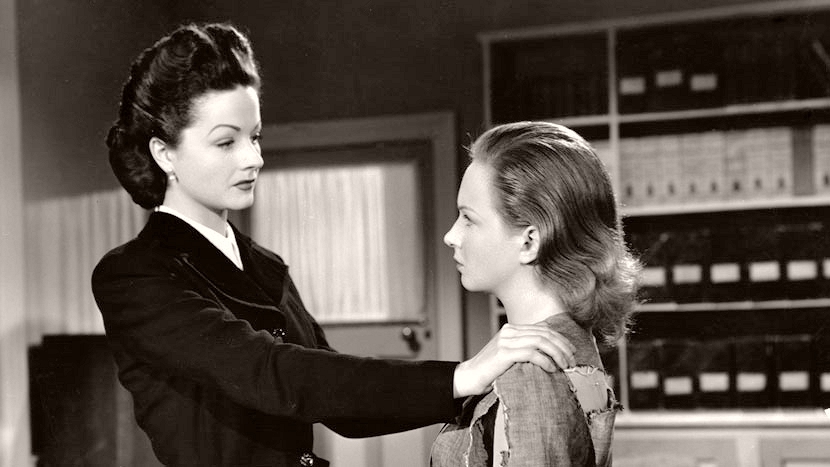Lucy (Margaret Lockwood) puts her arms on the shoulders of Lottie Smith (Joan Greenwood) in a scene from The White Unicorn (1947)